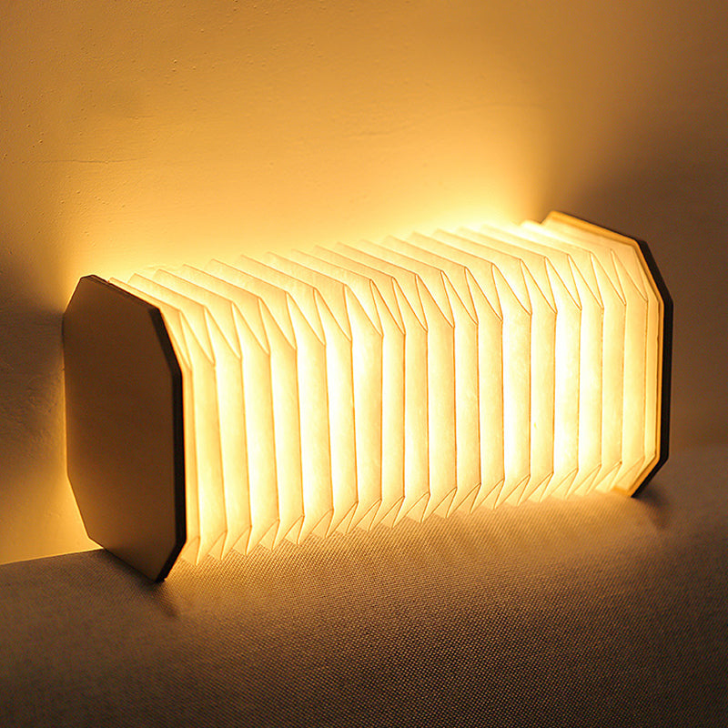 Wooden folding lamp on nightstand